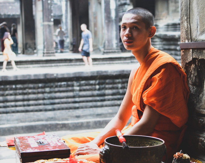 Monk sat at Ek Phnom Pagoda - GapGuru