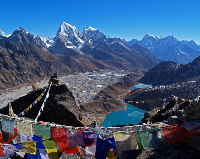 High in the mountains of Nepal with traditional flags strung from rock to rock - GapGuru
