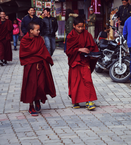 Young Buddhists walking down the street in Dharamshala - GapGuru