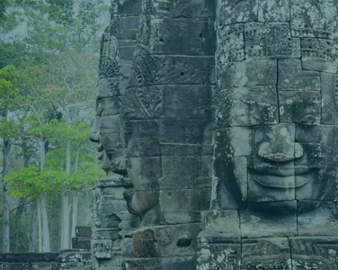 Faces of Buddha carved into a Cambodian temple ruin - GapGuru