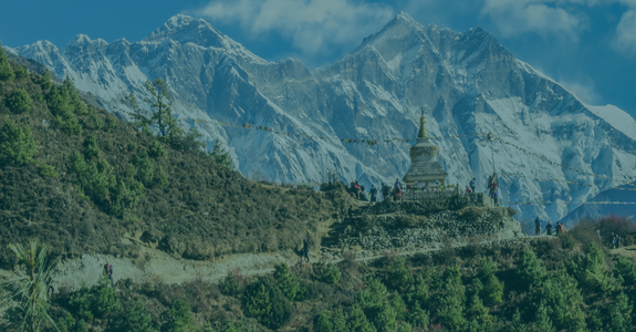 A shrine on a mountainside with a backdrop of the Himalayas - GapGuru