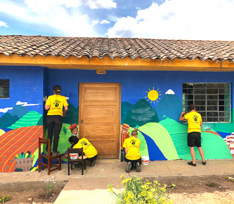 GapGuru team painting a school building - GapGuru